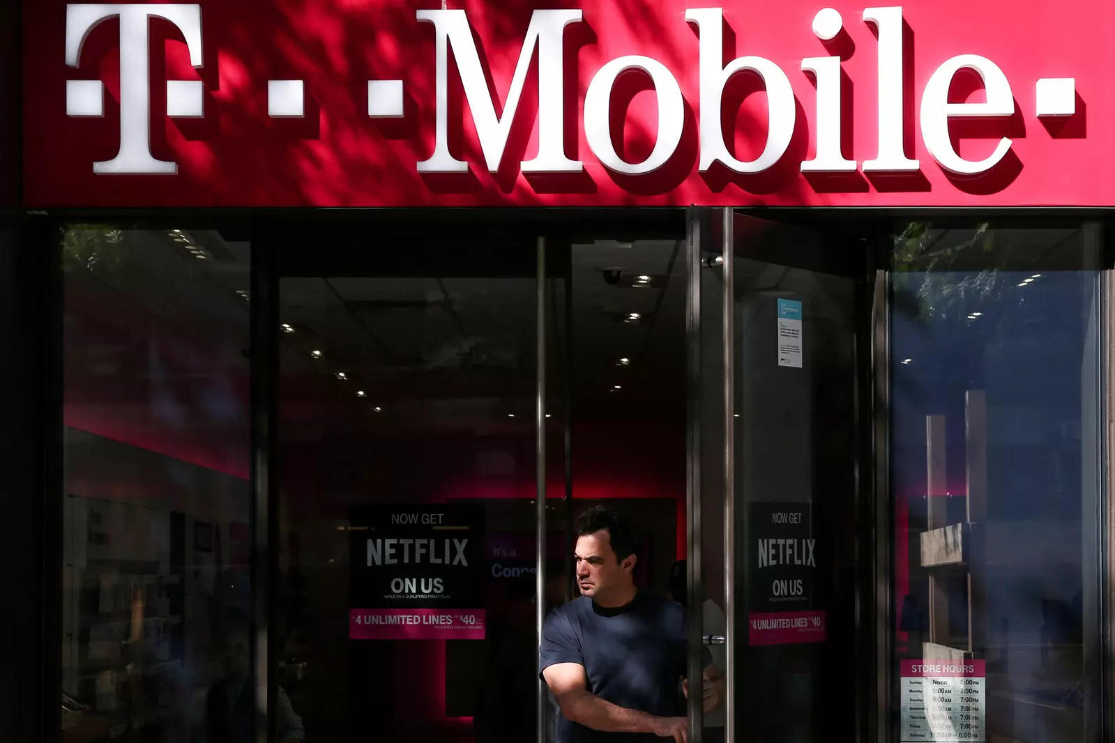  FILE PHOTO: A T-Mobile sign on top of a T-Mobile retail store in Manhattan, New York, U.S., September 22, 2017. REUTERS/Amr Alfiky/File Photo